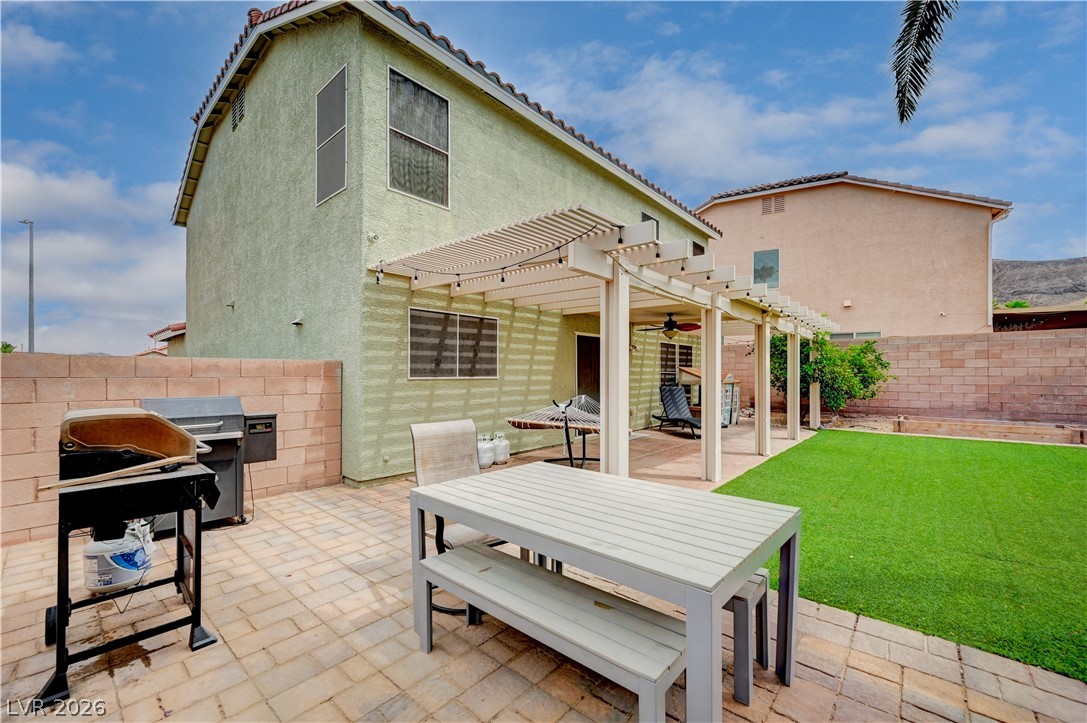 197 Kings Canyon Court Henderson, NV 89012 - Photo 38 of 39 View of patio / terrace featuring a pergola, outdoor dining space, area for grilling, and a ceiling fan