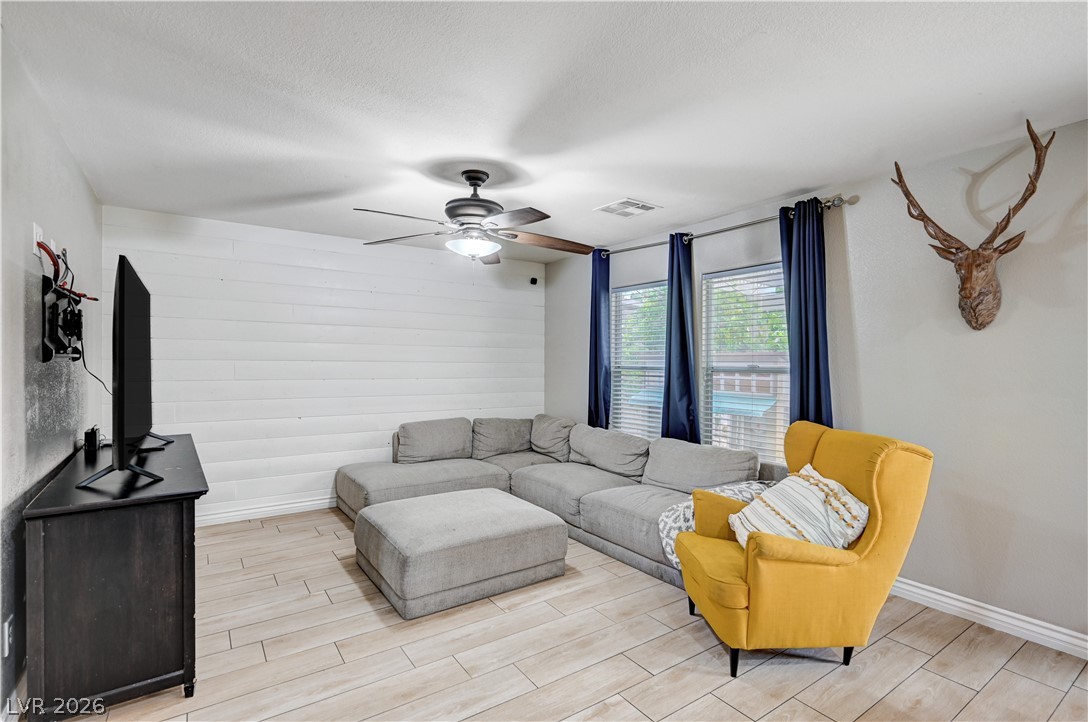 197 Kings Canyon Court Henderson, NV 89012 - Photo 4 of 39 Living room featuring light wood-style floors and a ceiling fan