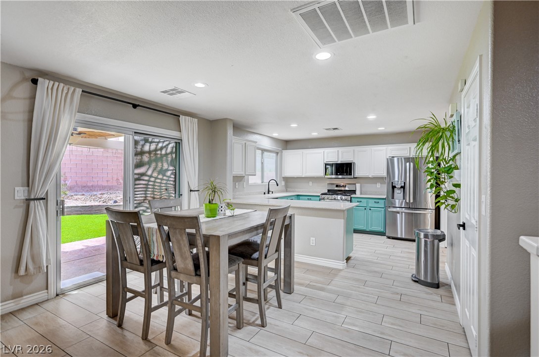 197 Kings Canyon Court Henderson, NV 89012 - Photo 7 of 39 Dining space with wood tiled floors and recessed lighting