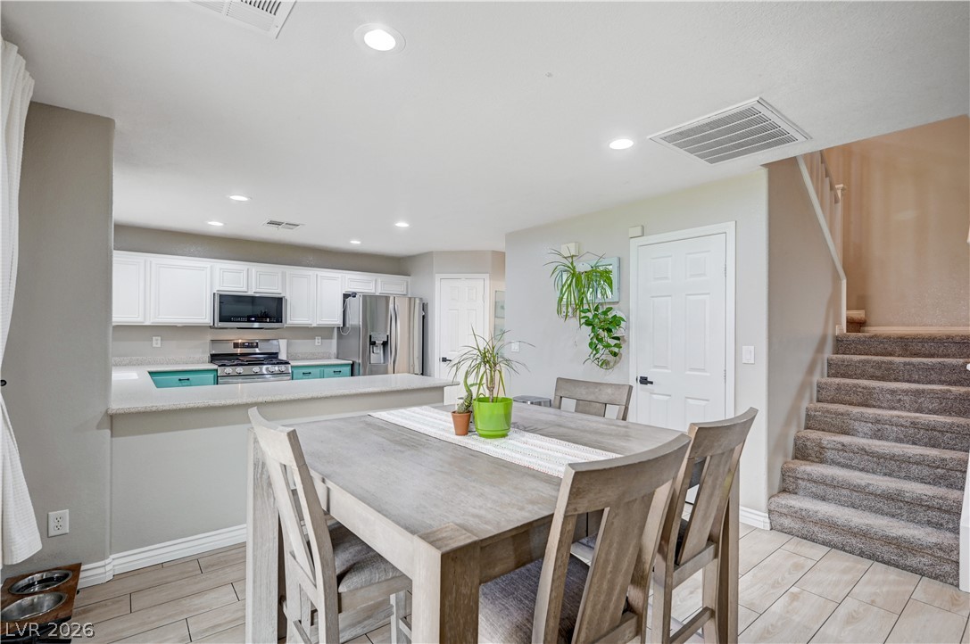 197 Kings Canyon Court Henderson, NV 89012 - Photo 8 of 39 Dining space featuring stairs, wood finish floors, and recessed lighting
