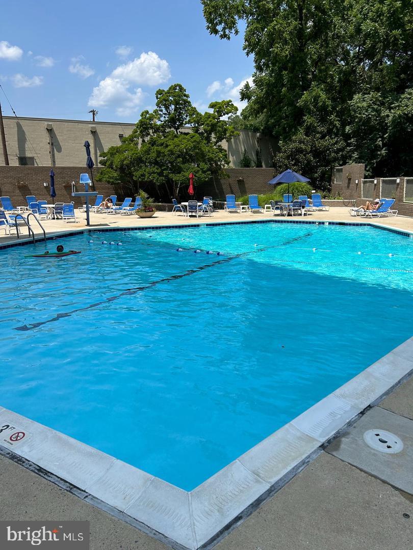 5101 River Road, Unit 1904 Bethesda, MD 20816 - Photo 34 of 43 a view of a swimming pool with an outdoor space and seating area