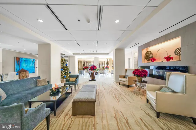 a living room with furniture and a chandelier
