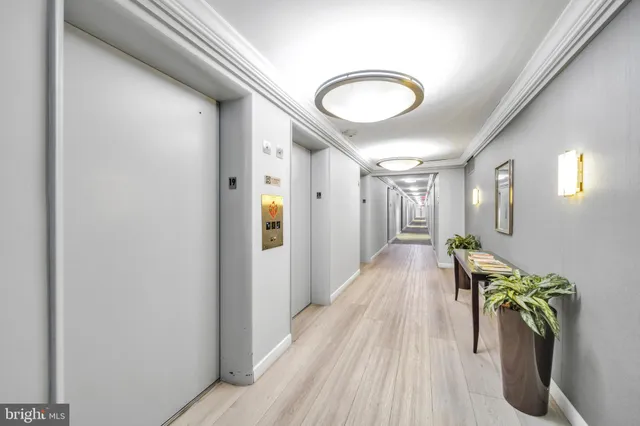a view of a hallway with wooden floor and stairs