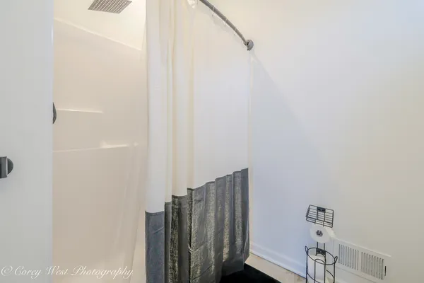 a view of walk in closet with wooden floor