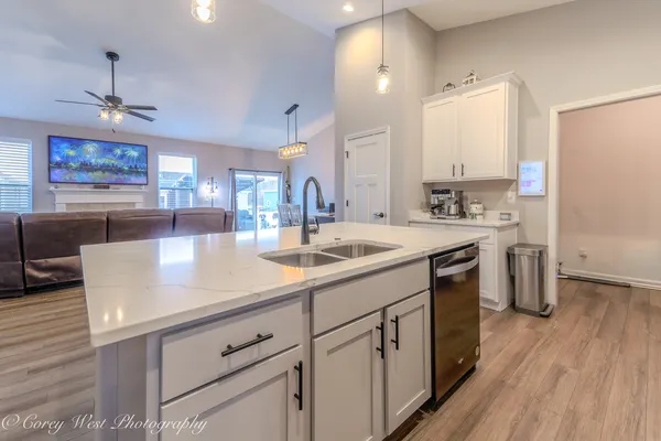 a kitchen with sink cabinets and wooden floor