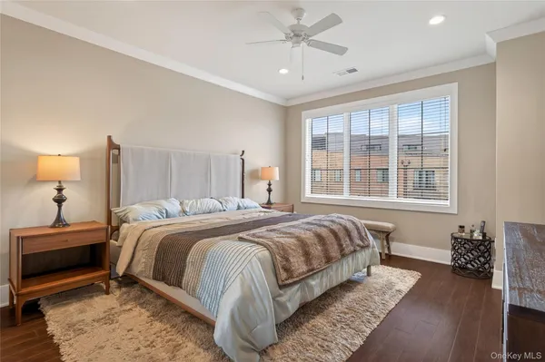 a bedroom with a bed lamp and a window