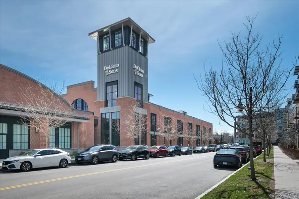 a couple of cars parked in front of brick building
