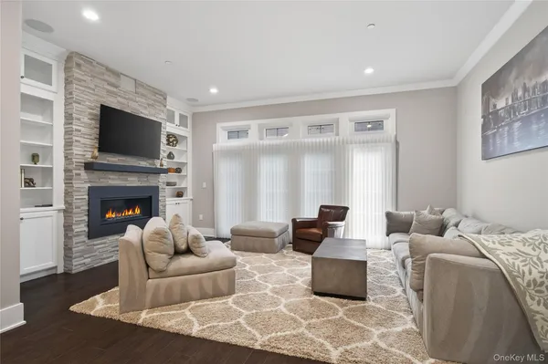a living room with furniture fireplace and flat screen tv