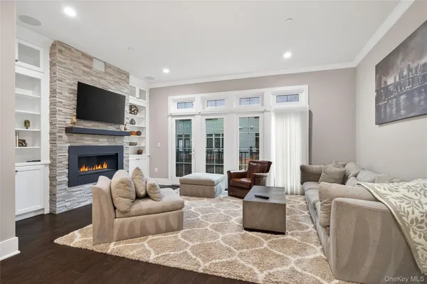 a living room with furniture fireplace and flat screen tv