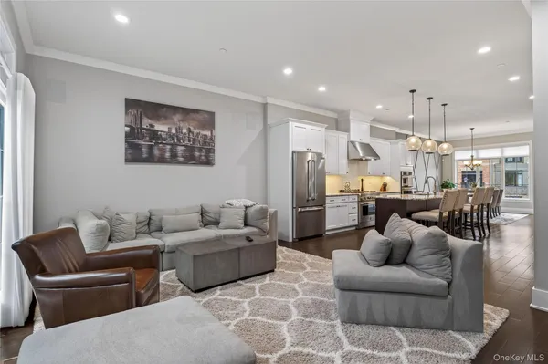 a living room with furniture and a view of kitchen