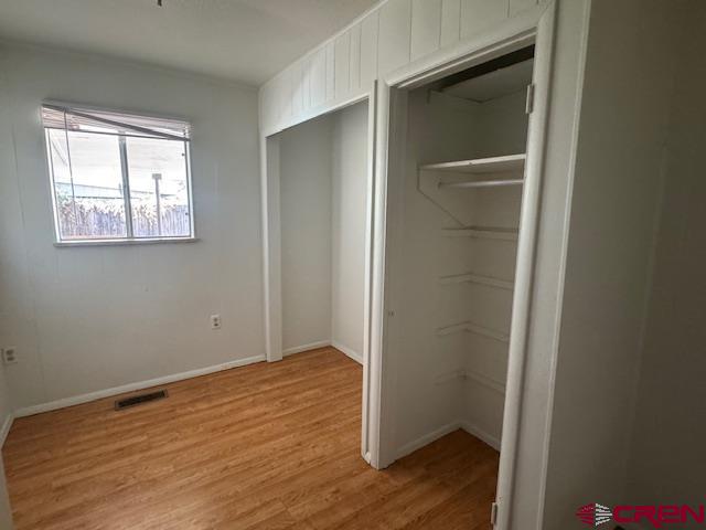630 East Fourth Street, Unit A AND B Cortez, CO 81321 - Photo 12 of 28 a view of an empty room with wooden floor and a window