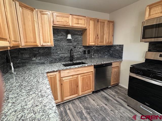 630 East Fourth Street, Unit A AND B Cortez, CO 81321 - Photo 13 of 28 a kitchen with stainless steel appliances granite countertop a stove a sink and a microwave