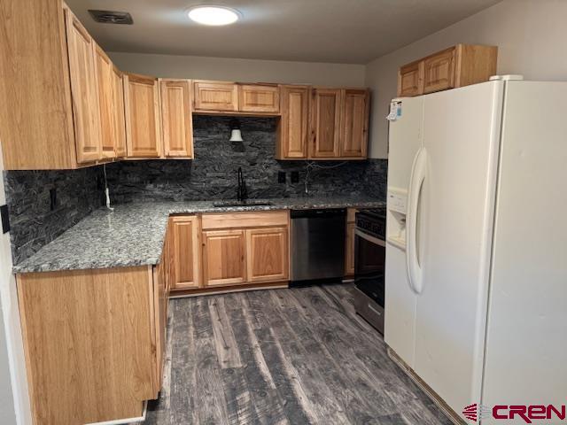 630 East Fourth Street, Unit A AND B Cortez, CO 81321 - Photo 15 of 28 a kitchen with granite countertop a refrigerator and a sink