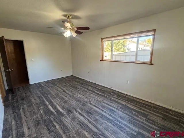 a view of a livingroom with a ceiling fan and a window