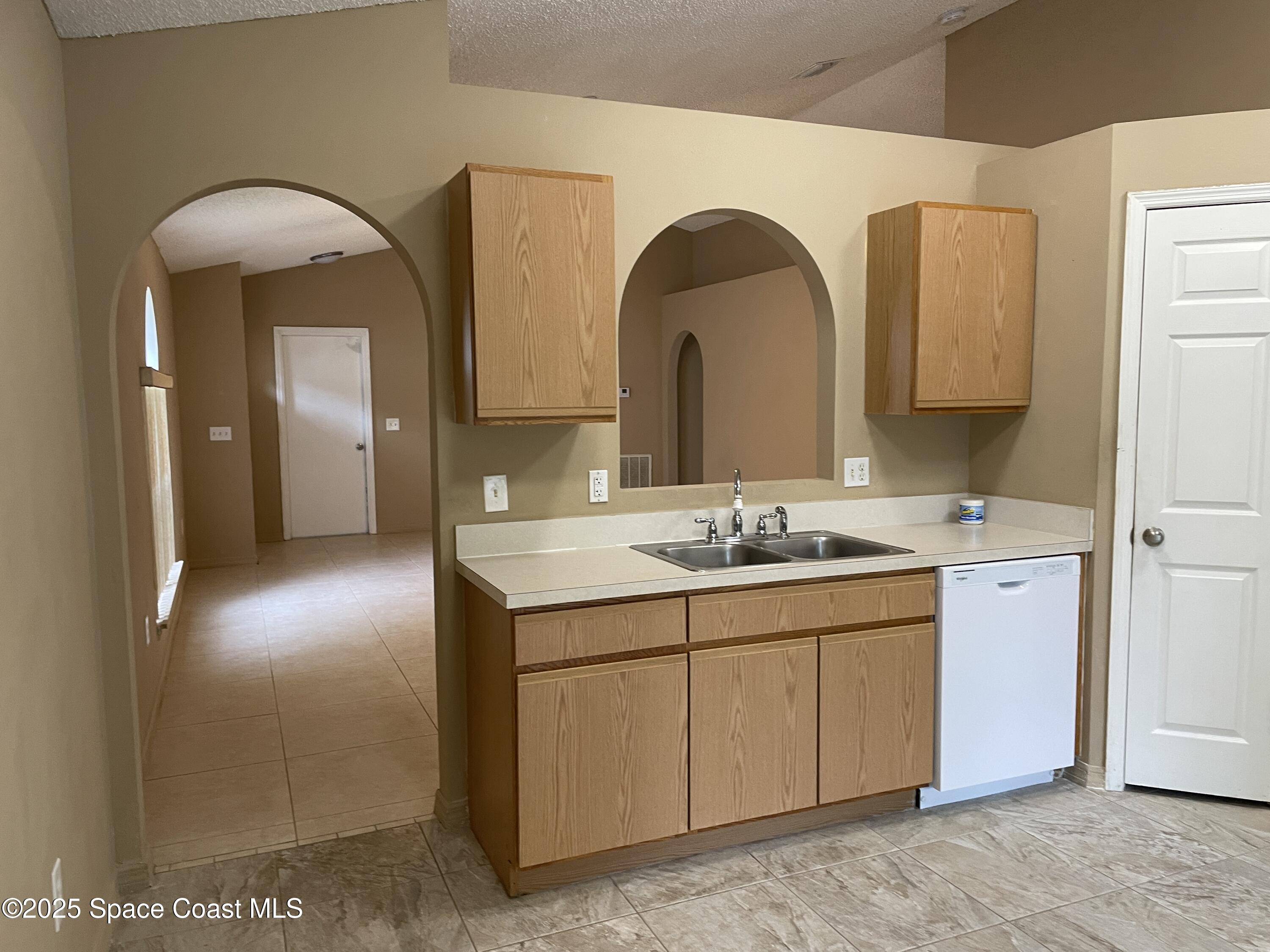 2065 Redwood Circle Palm Bay, FL 32905 - Photo 2 of 12 a bathroom with a double vanity sink and a mirror