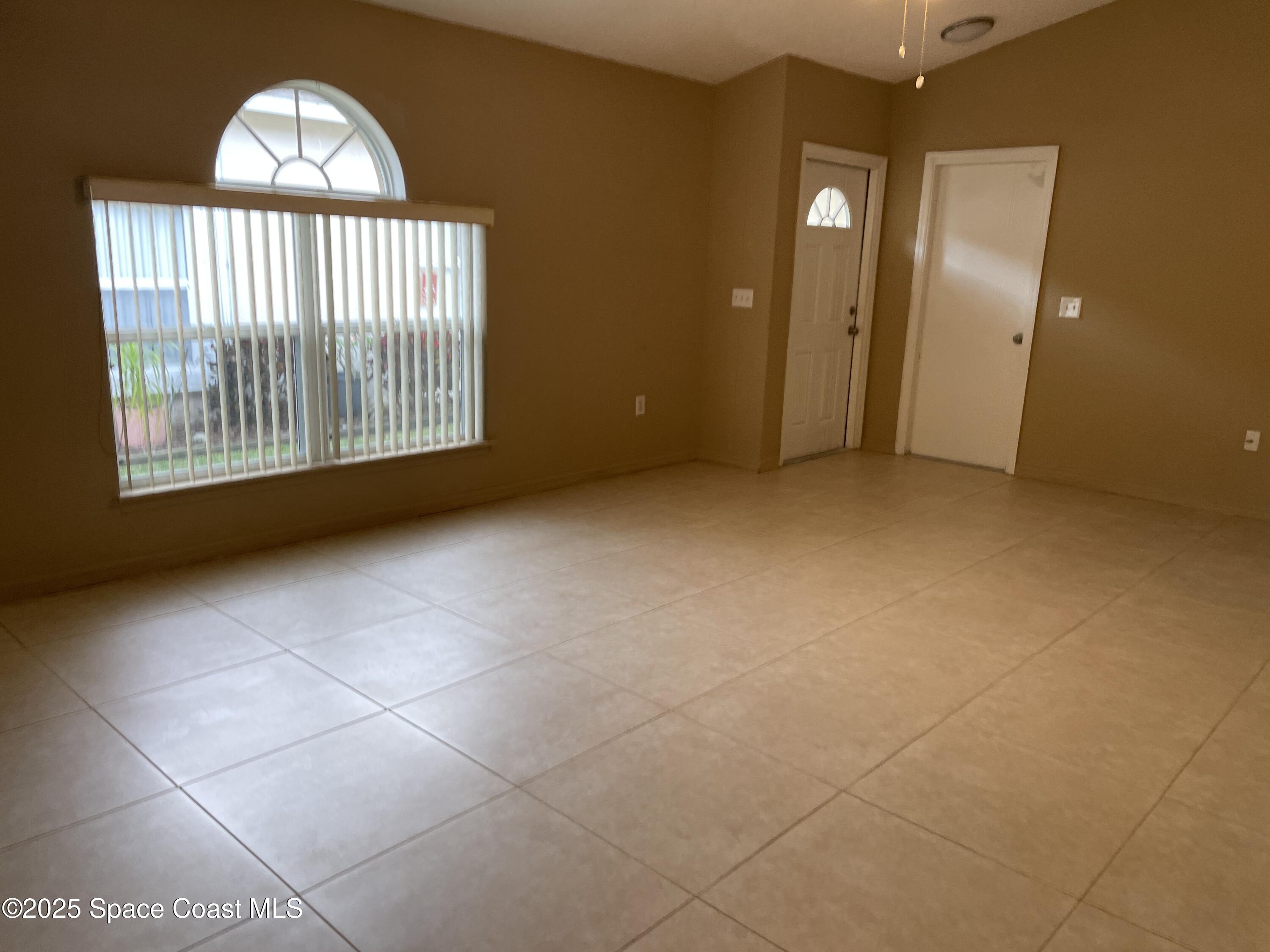 2065 Redwood Circle Palm Bay, FL 32905 - Photo 5 of 12 a view of an empty room with a window