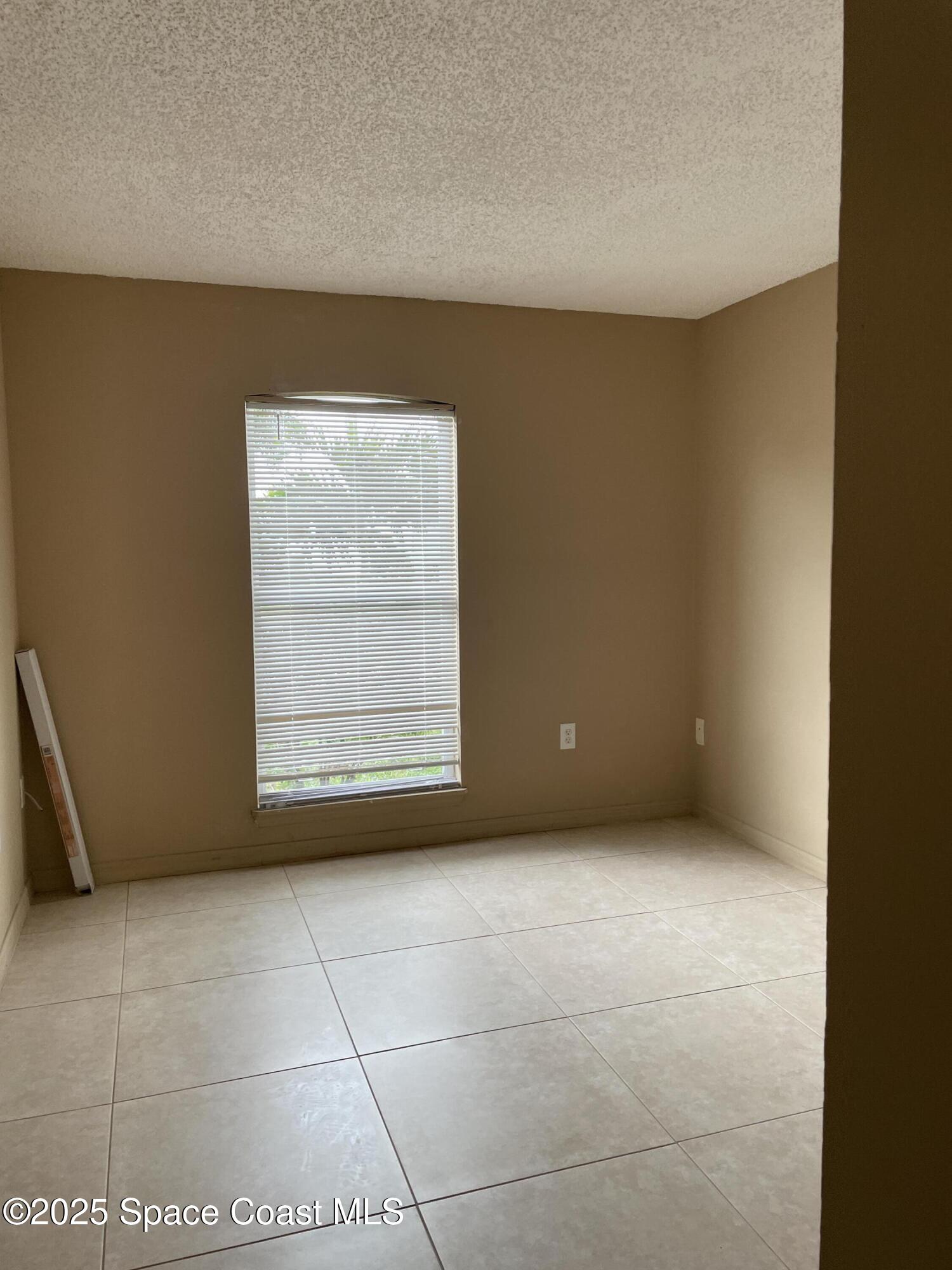 2065 Redwood Circle Palm Bay, FL 32905 - Photo 7 of 12 a view of an empty room with a window