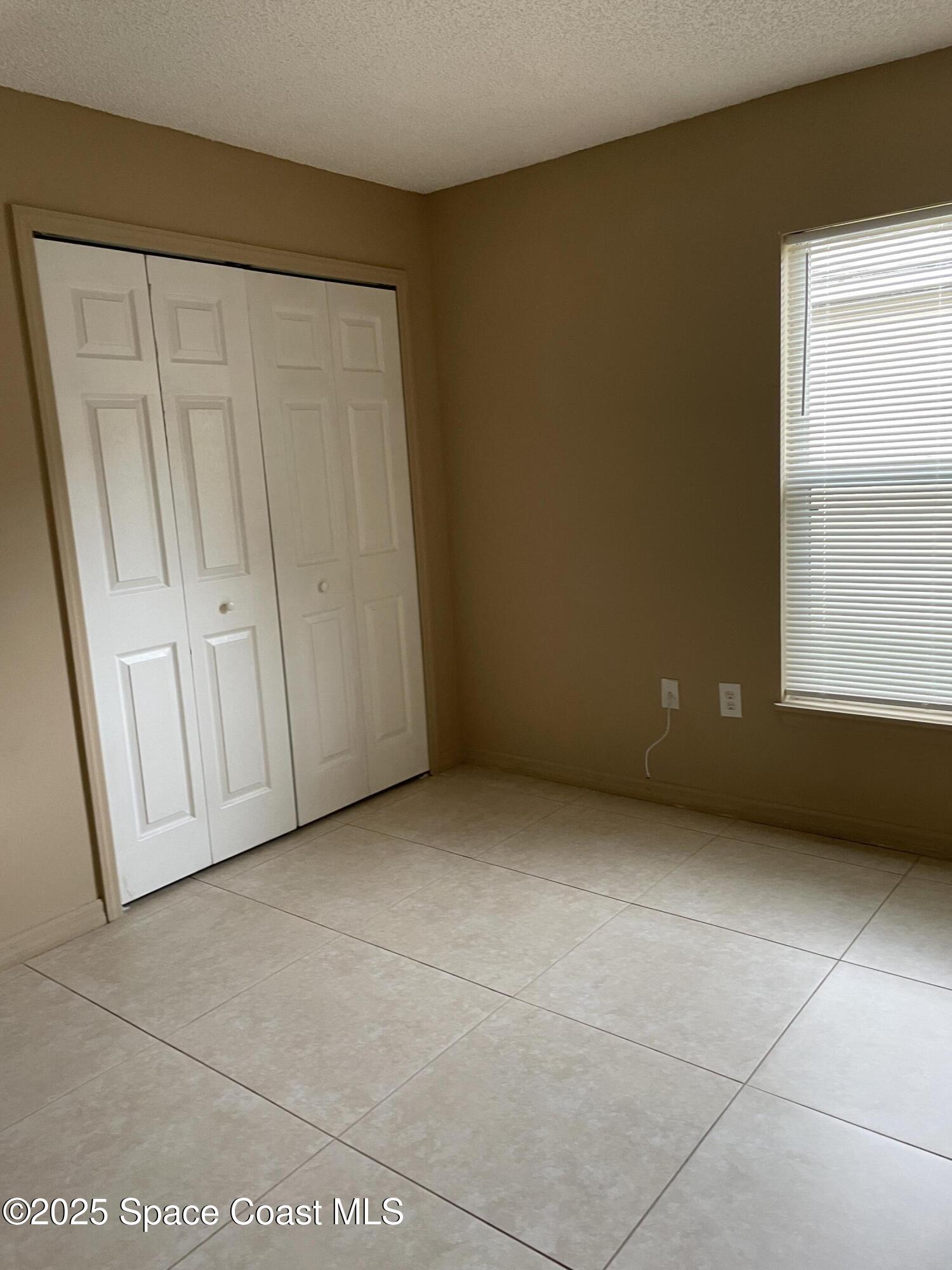 2065 Redwood Circle Palm Bay, FL 32905 - Photo 8 of 12 a view of an empty room with a window