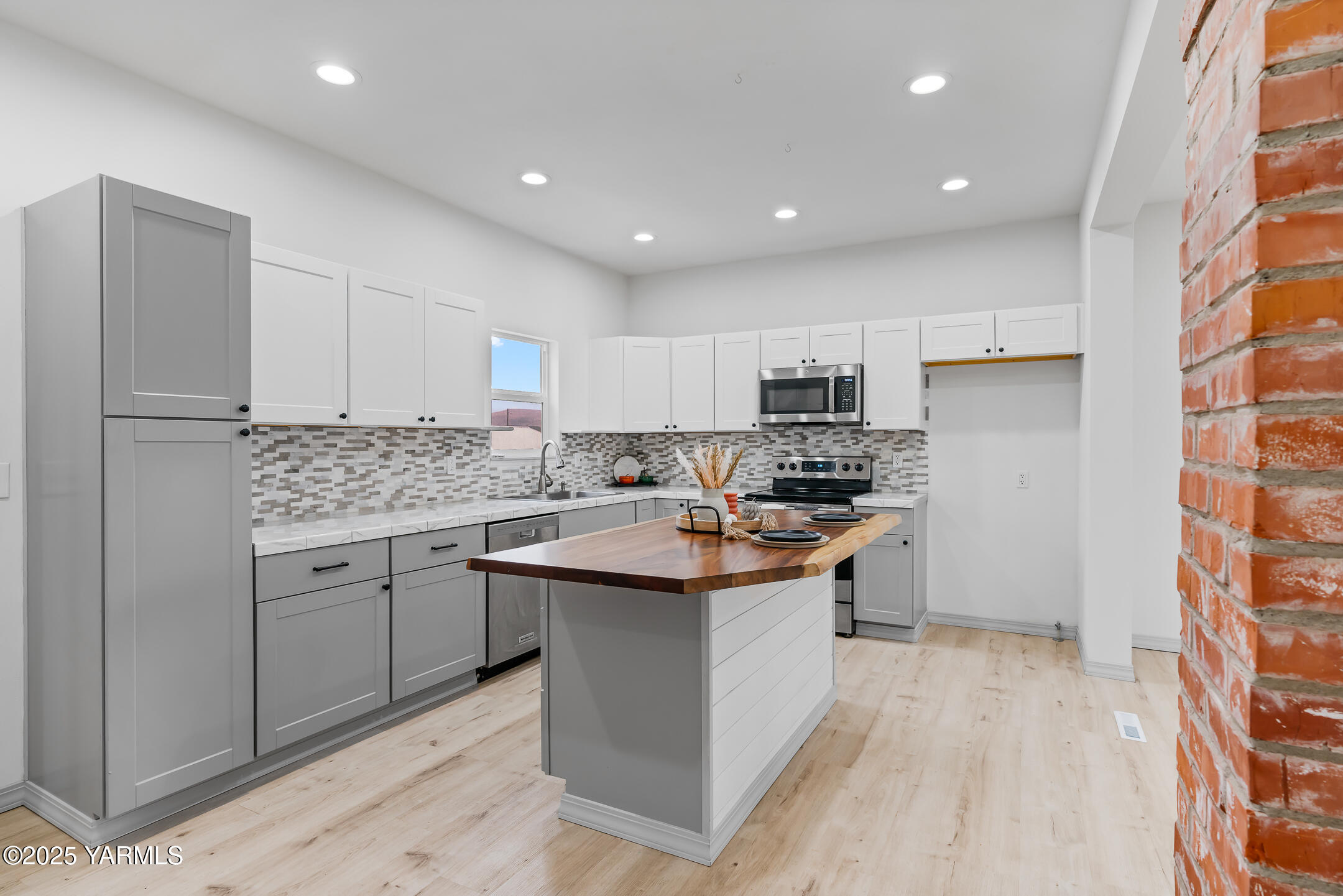 1891 North Wenas Road Selah, WA 98942 - Photo 11 of 27 a kitchen with white cabinets sink and stainless steel appliances