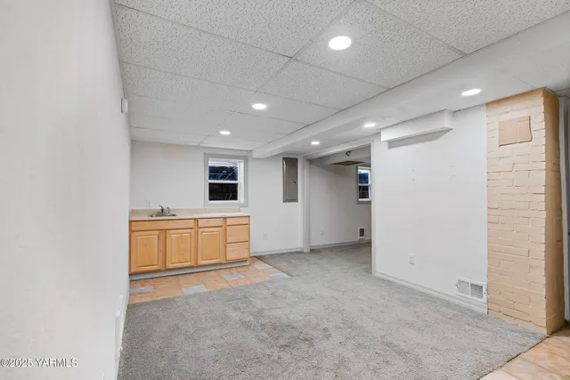 an empty room with a kitchen