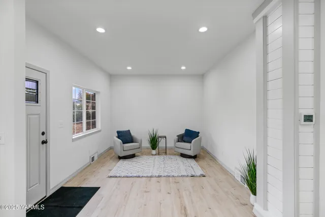 a view of living room filled with furniture and wooden floor