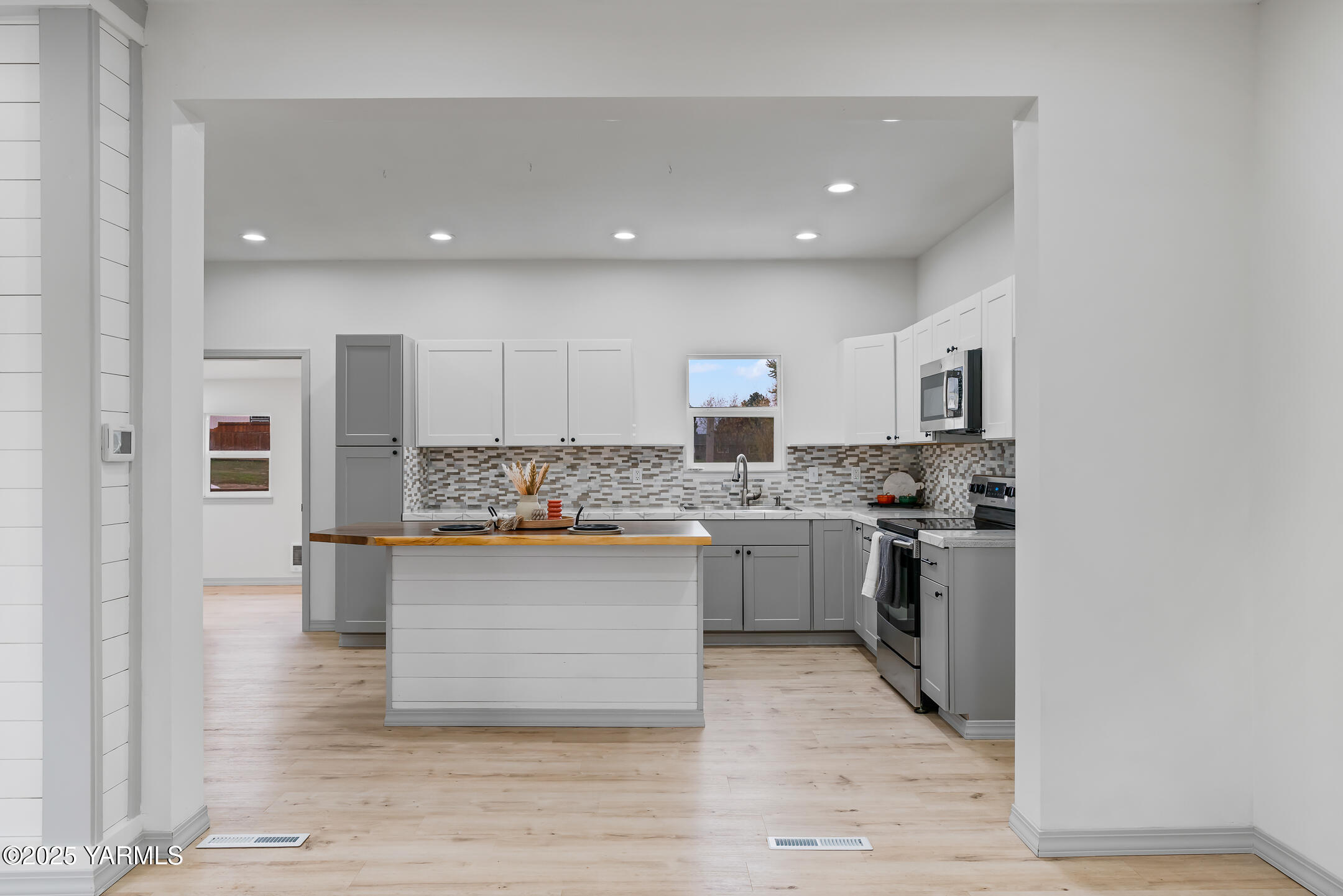 1891 North Wenas Road Selah, WA 98942 - Photo 9 of 27 a kitchen with stainless steel appliances granite countertop a stove top oven a sink dishwasher and a refrigerator