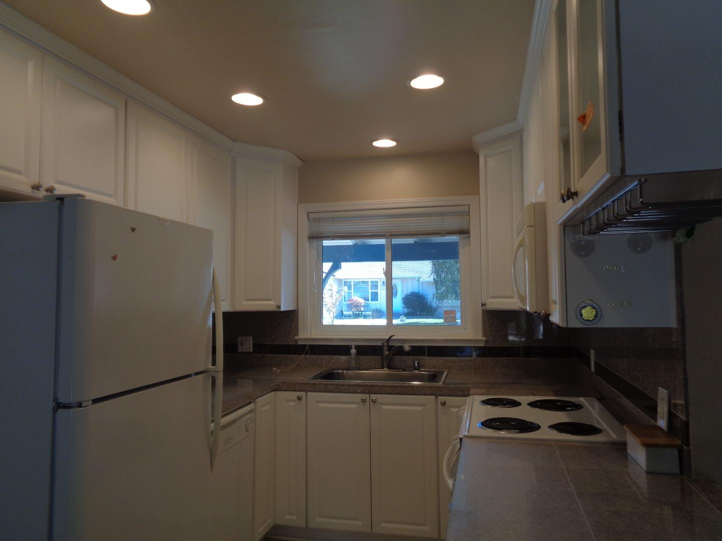 127 Dogwood Place San Ramon, CA 94583 - Photo 2 of 10 a kitchen with granite countertop white cabinets and refrigerator