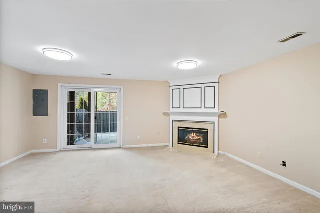 a view of an empty room with a fireplace