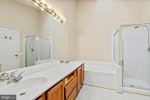 a bathroom with a tub sink and mirror