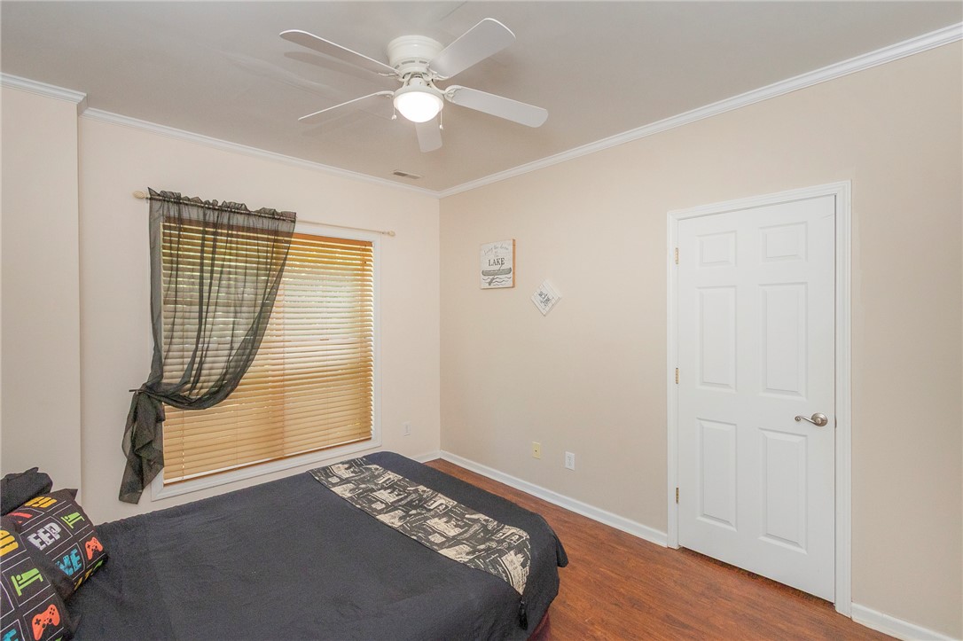 125 Inlet Pointe Drive Anderson, SC 29625 - Photo 32 of 39 Hardwood flooring extends throughout this well-lit bedroom featuring a ceiling fan and natural light.