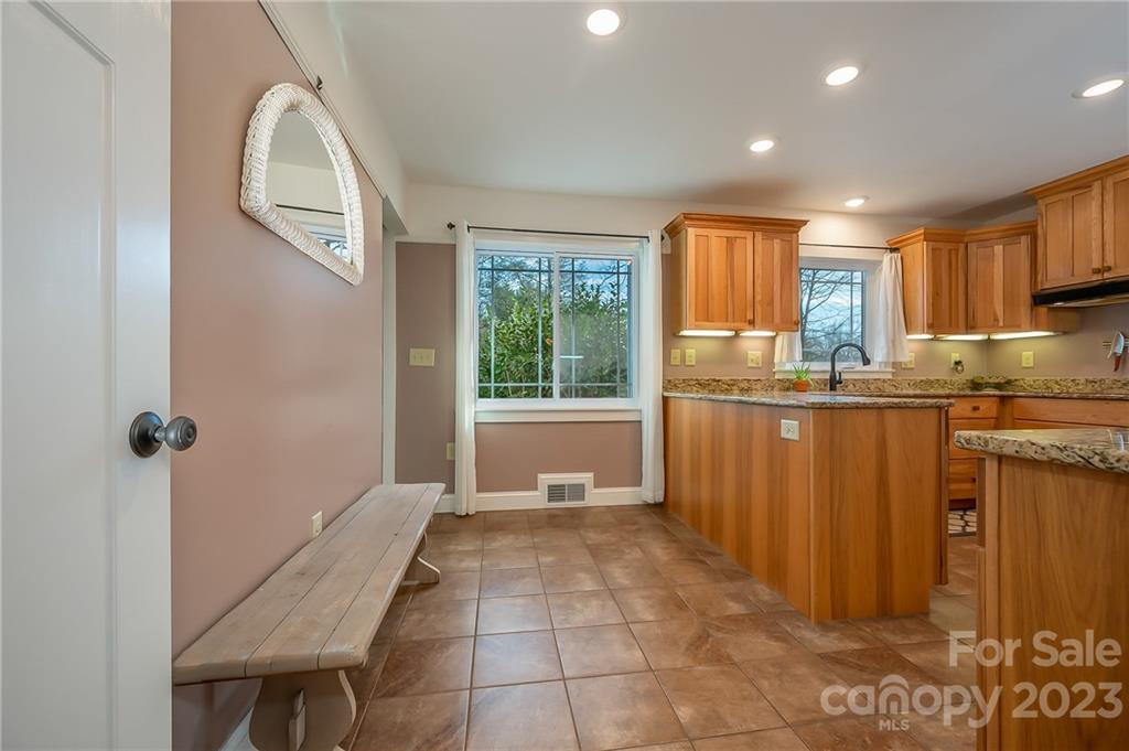 72 Doubleday Road Tryon, NC 28782 - Photo 21 of 46 a kitchen with granite countertop a stove a sink and a refrigerator