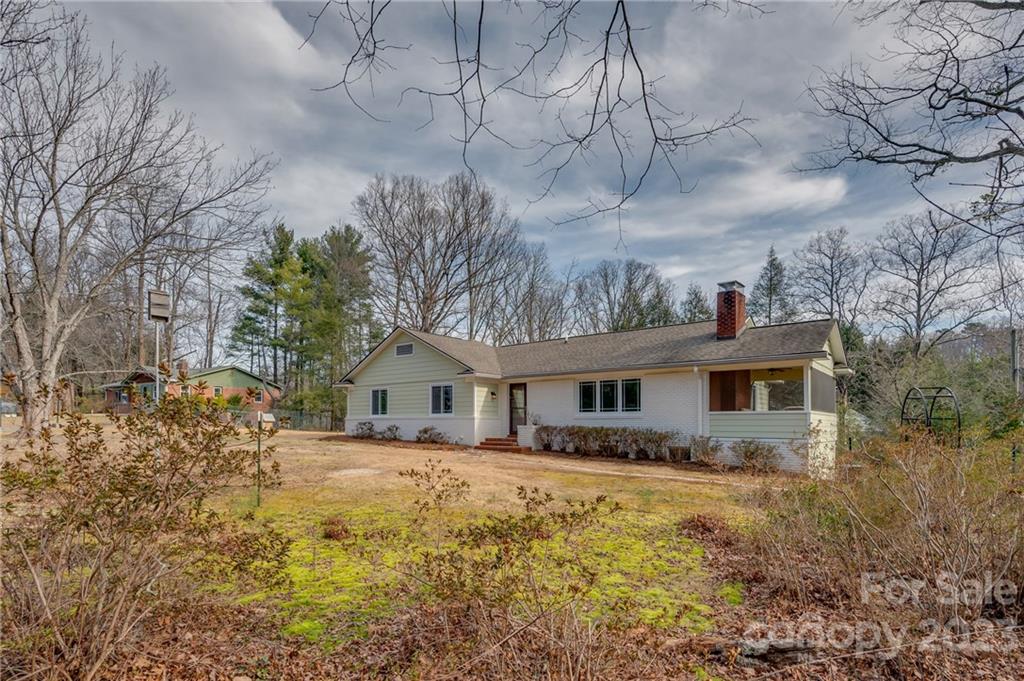 72 Doubleday Road Tryon, NC 28782 - Photo 3 of 46 a front view of house with yard and trees around