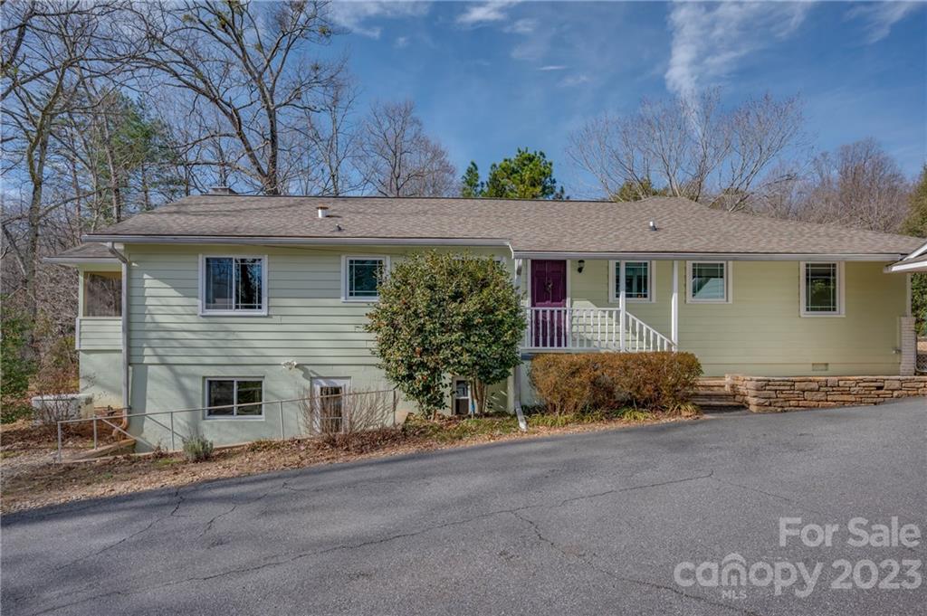 72 Doubleday Road Tryon, NC 28782 - Photo 39 of 46 a view of a house with a yard and garage