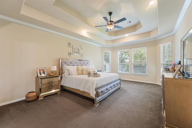 a bed room with a bed and a ceiling fan