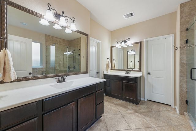 a bathroom with a sink vanity and a mirror