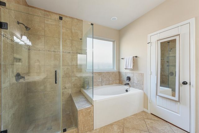 a bathroom with a bathtub and shower