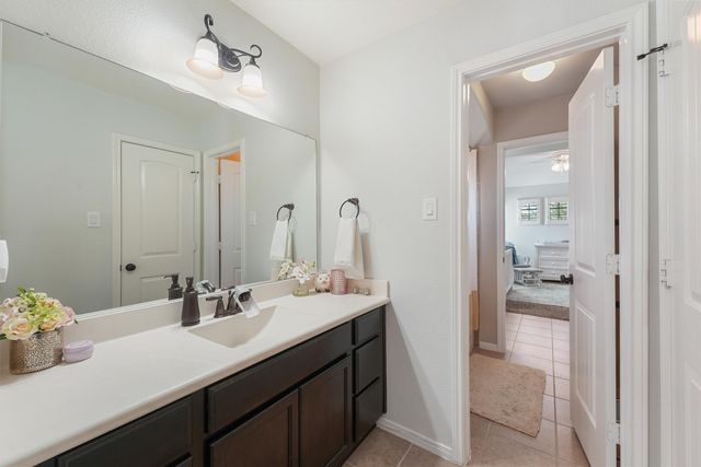 a en suite bathroom with a sink double vanity and a mirror