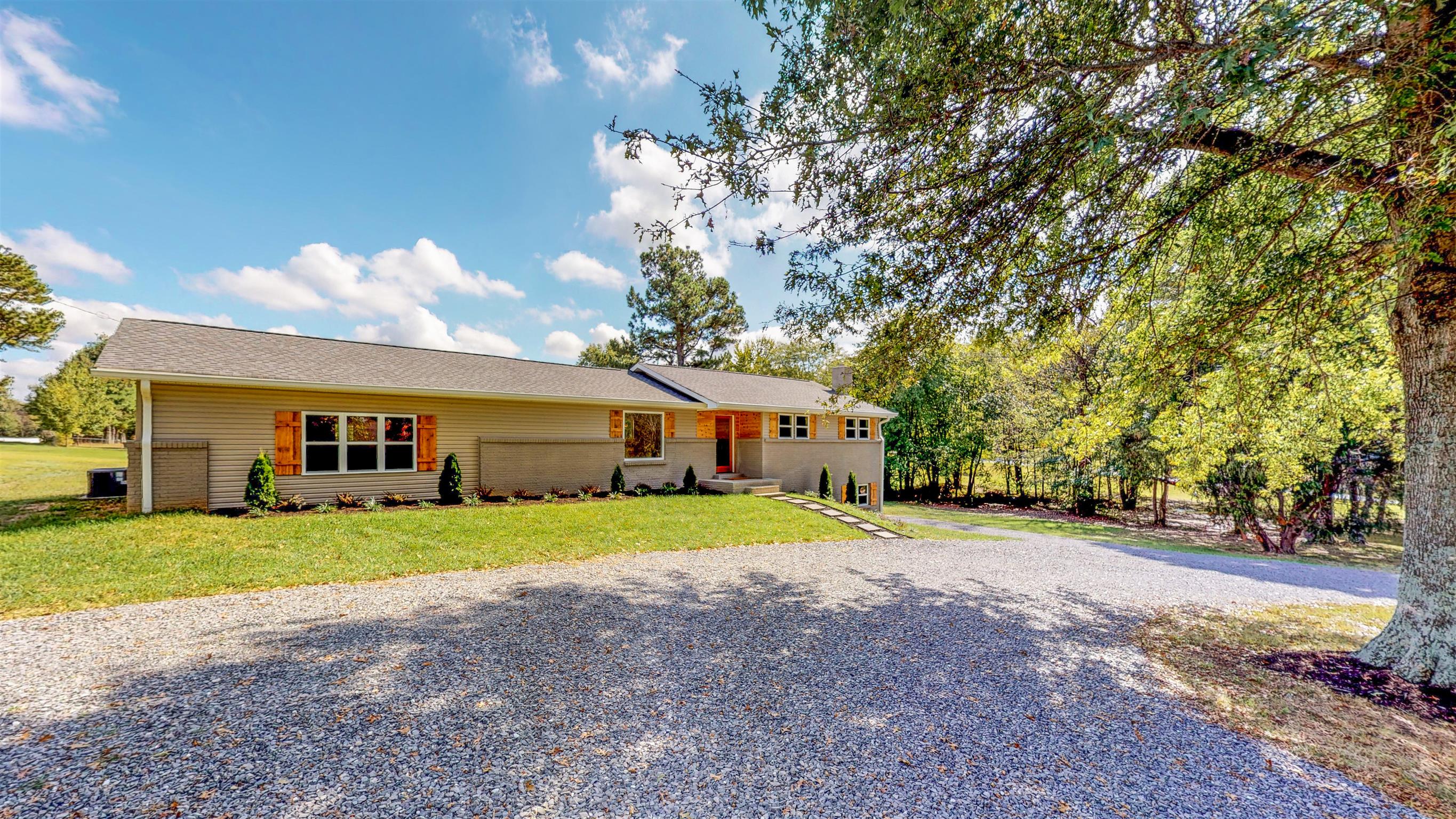 110 Green Acres Road Cottontown, TN 37048 - Photo 2 of 28 a front view of a house with a yard and garage