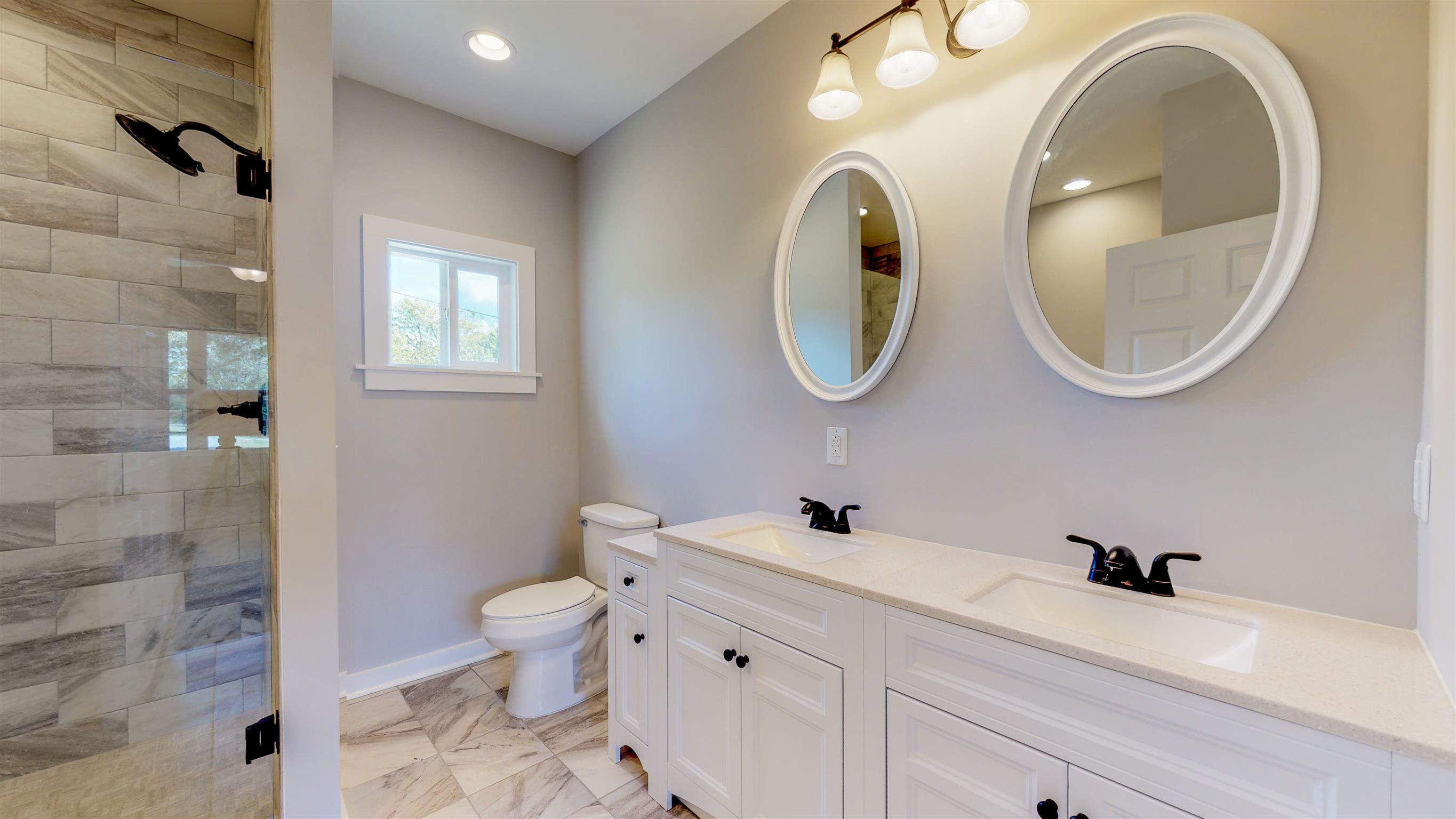 110 Green Acres Road Cottontown, TN 37048 - Photo 11 of 28 a bathroom with a toilet a sink and a mirror