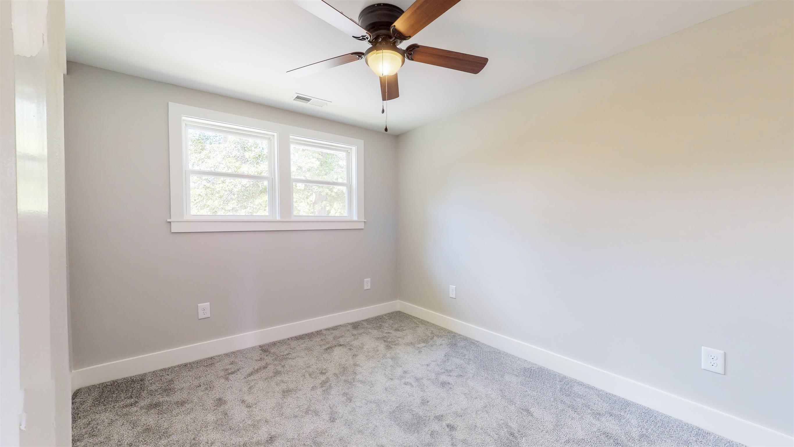 110 Green Acres Road Cottontown, TN 37048 - Photo 16 of 28 an empty room with a window and a fan