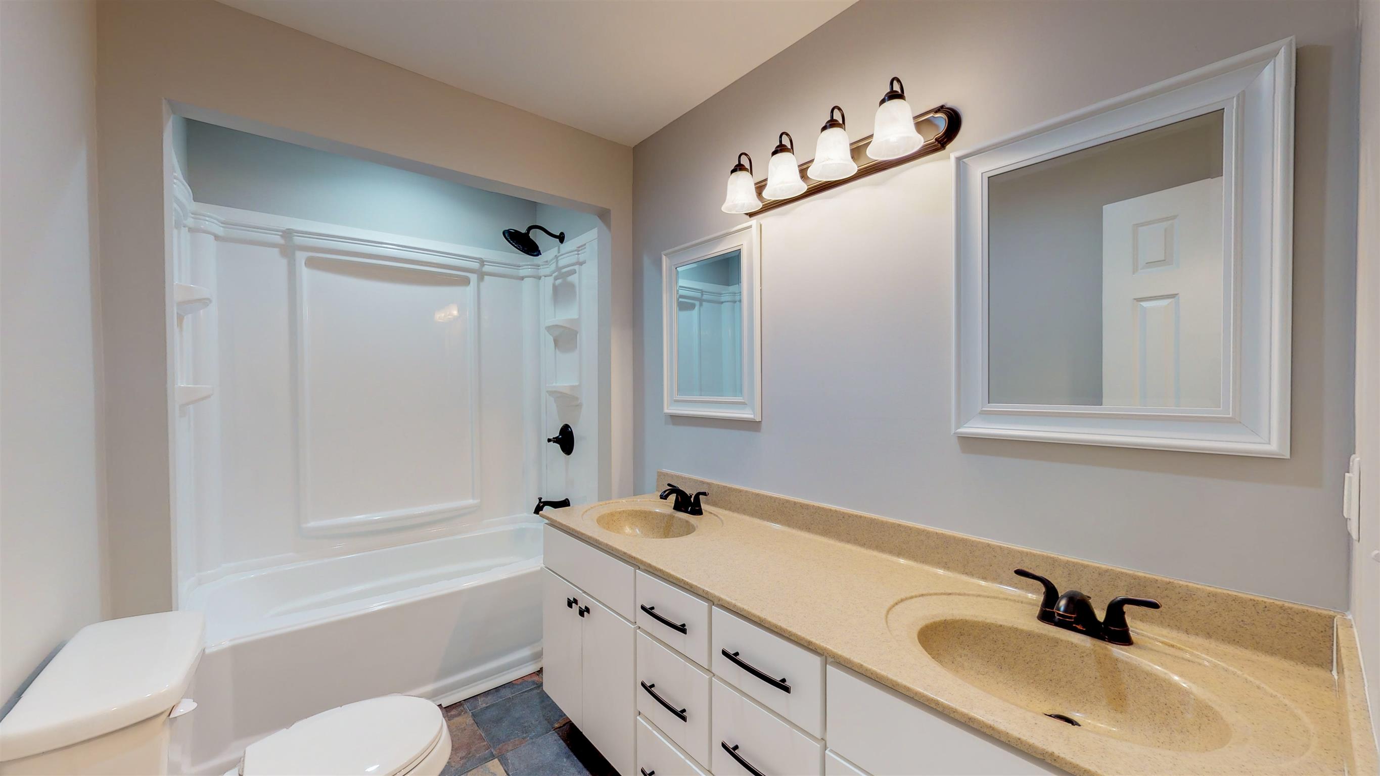 110 Green Acres Road Cottontown, TN 37048 - Photo 18 of 28 a bathroom with a tub a sink and mirror