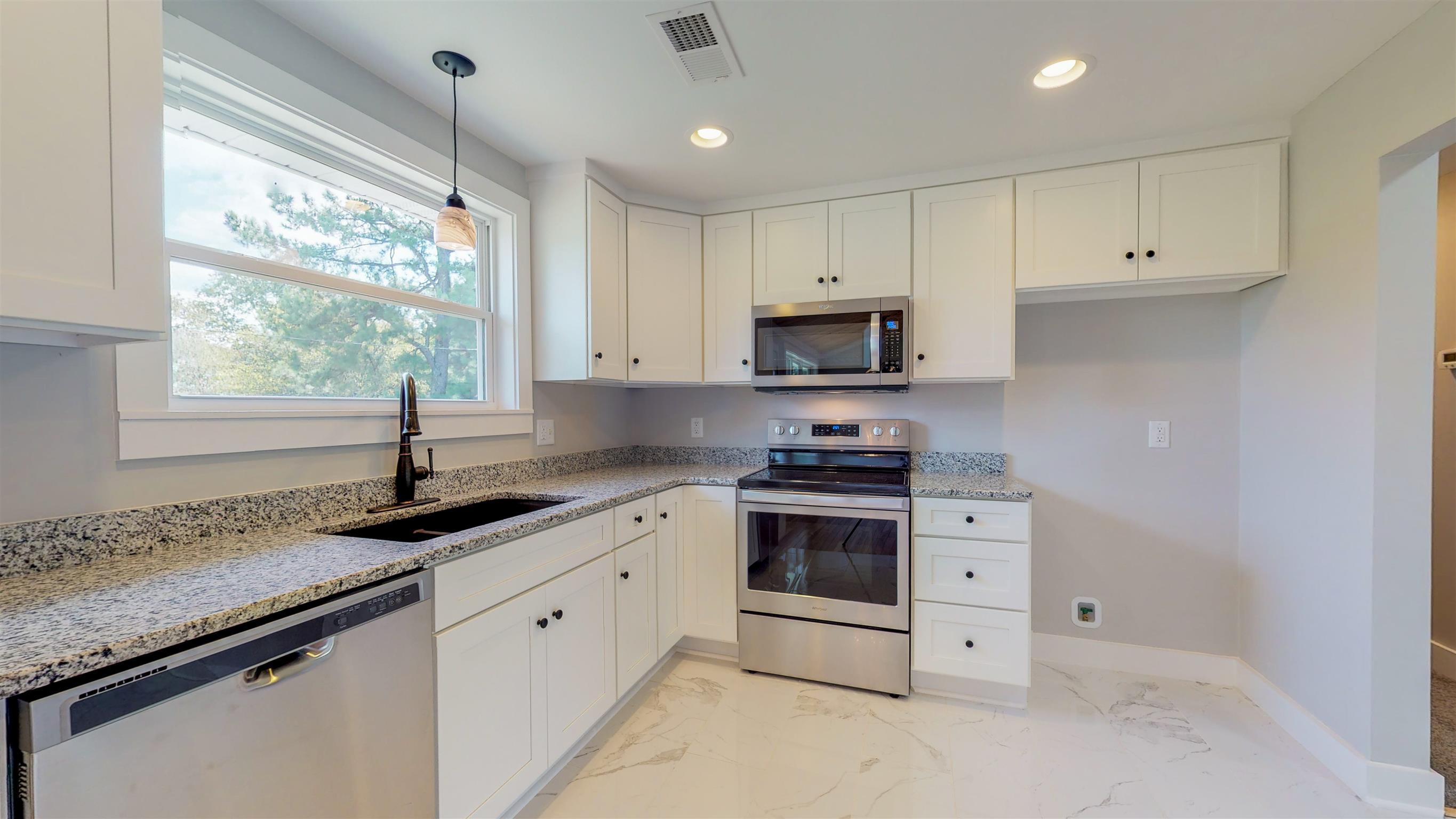 110 Green Acres Road Cottontown, TN 37048 - Photo 7 of 28 a kitchen with granite countertop white cabinets white appliances and a sink