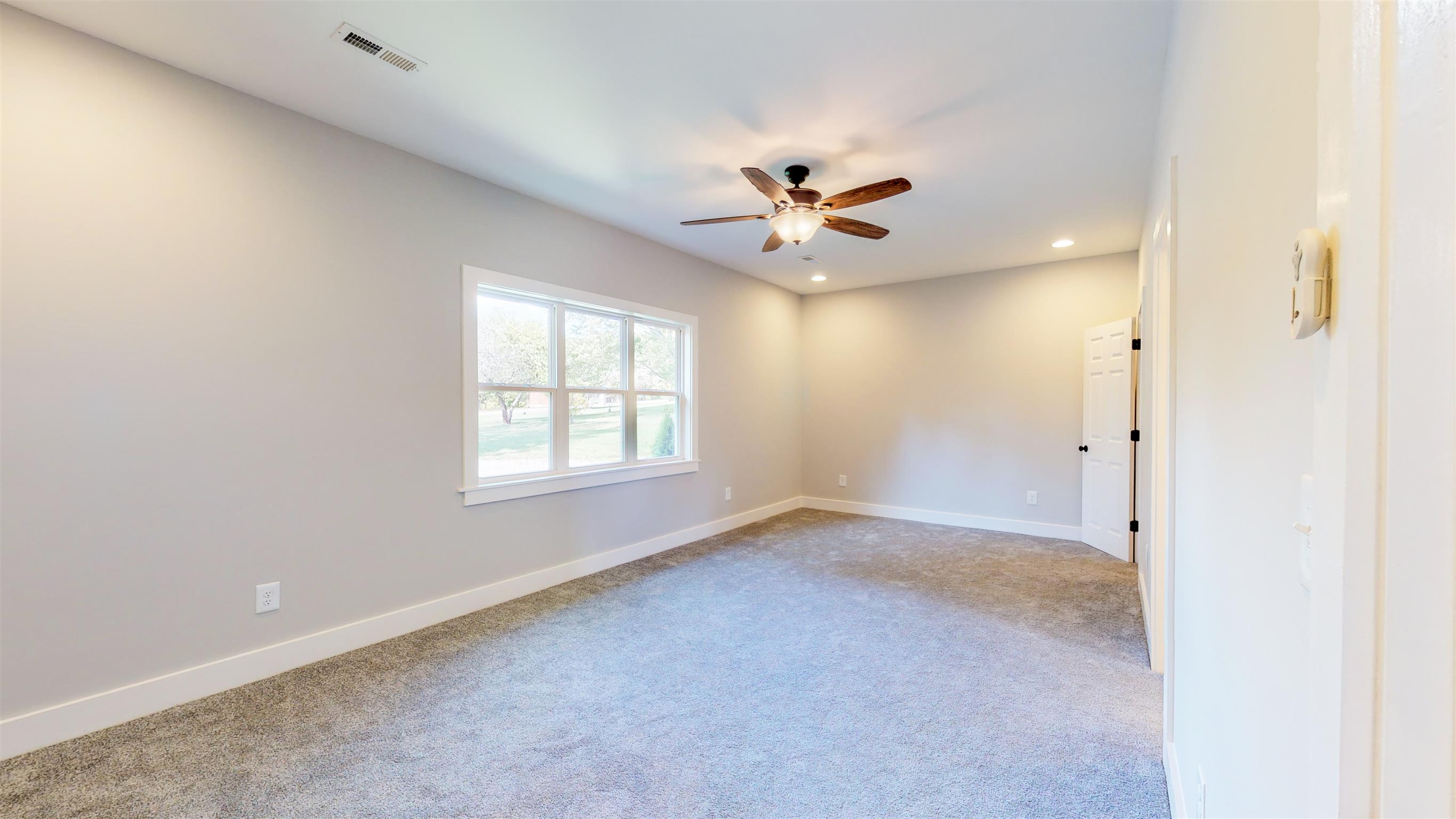110 Green Acres Road Cottontown, TN 37048 - Photo 10 of 28 an empty room with a ceiling fan and a window