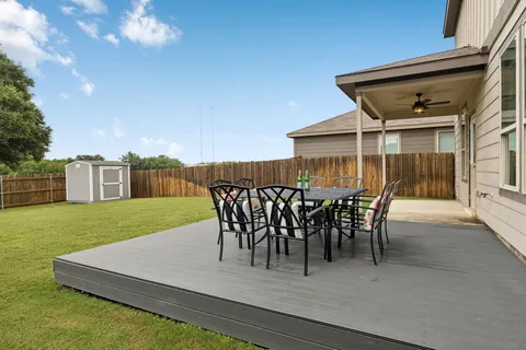a view of a house with patio and a yard