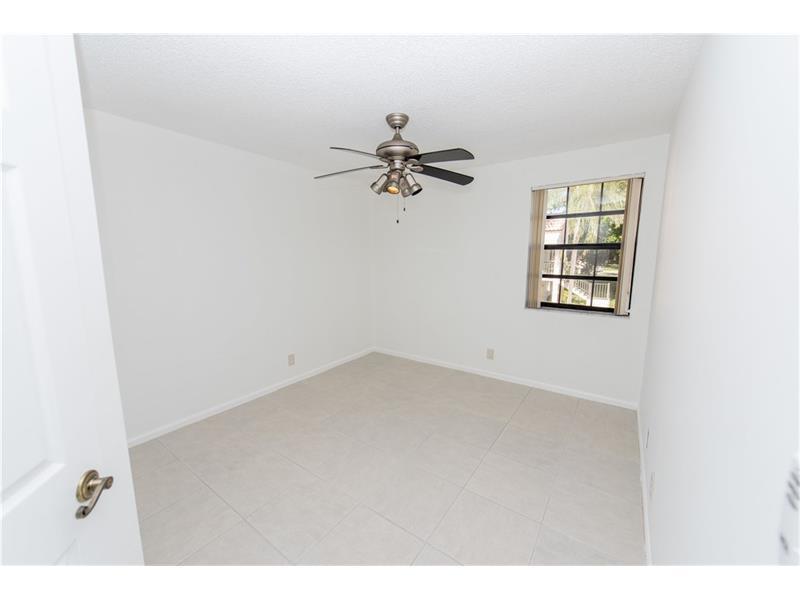 3150 Leewood Terrace, Unit L224 Boca Raton, FL 33431 - Photo 6 of 14 an empty room with windows and fan