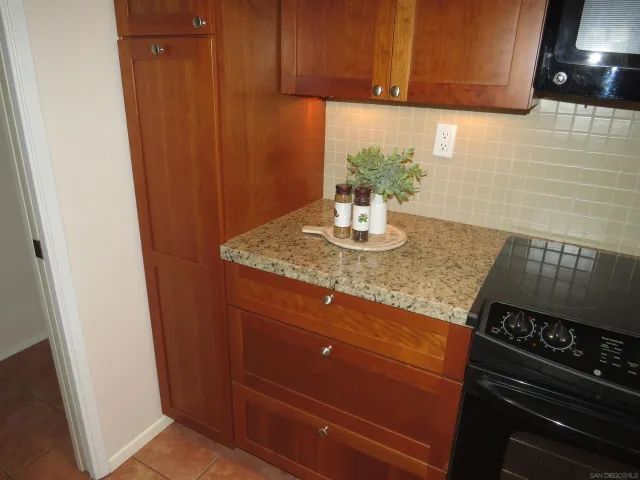 a kitchen with a sink a window and cabinets