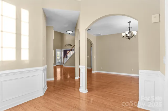 a view of a hallway view with wooden floor and staircase