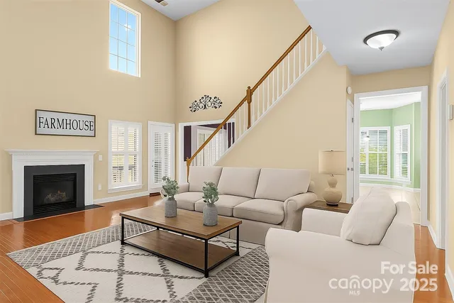 a living room with furniture a fireplace and a table