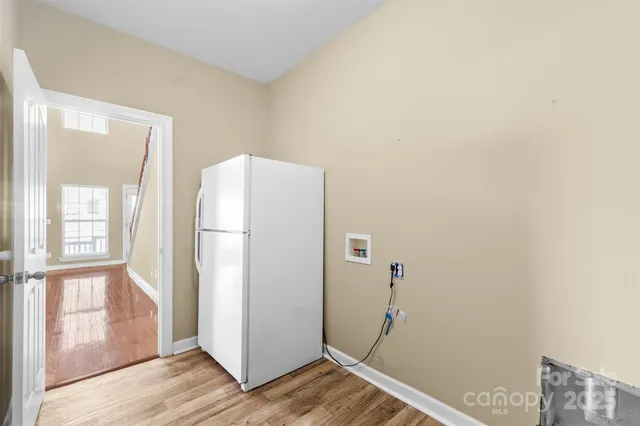 a view of hallway with wooden floor and entryway