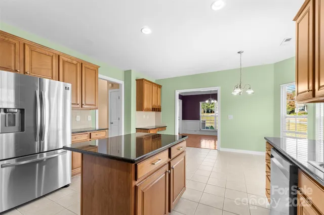 a kitchen with stainless steel appliances granite countertop a refrigerator and a sink